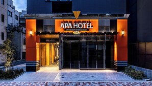 The exterior of the APA HOTEL with a modern design, featuring a prominent entrance and illuminated signage. - APA Hotel Ueno Okachimachi Ekimae Minami (Tokyo)