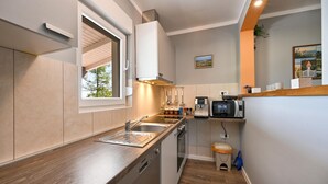 A compact kitchen with a window, built-in oven, and a coffee machine. - Stunning home in Sveti Kriz (Sveti Kriz)