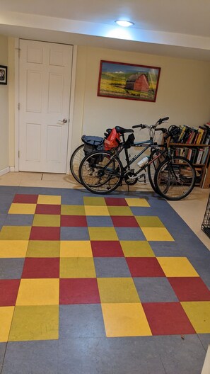 Cozy retreat with a bookshelf, bicycle, and artwork.