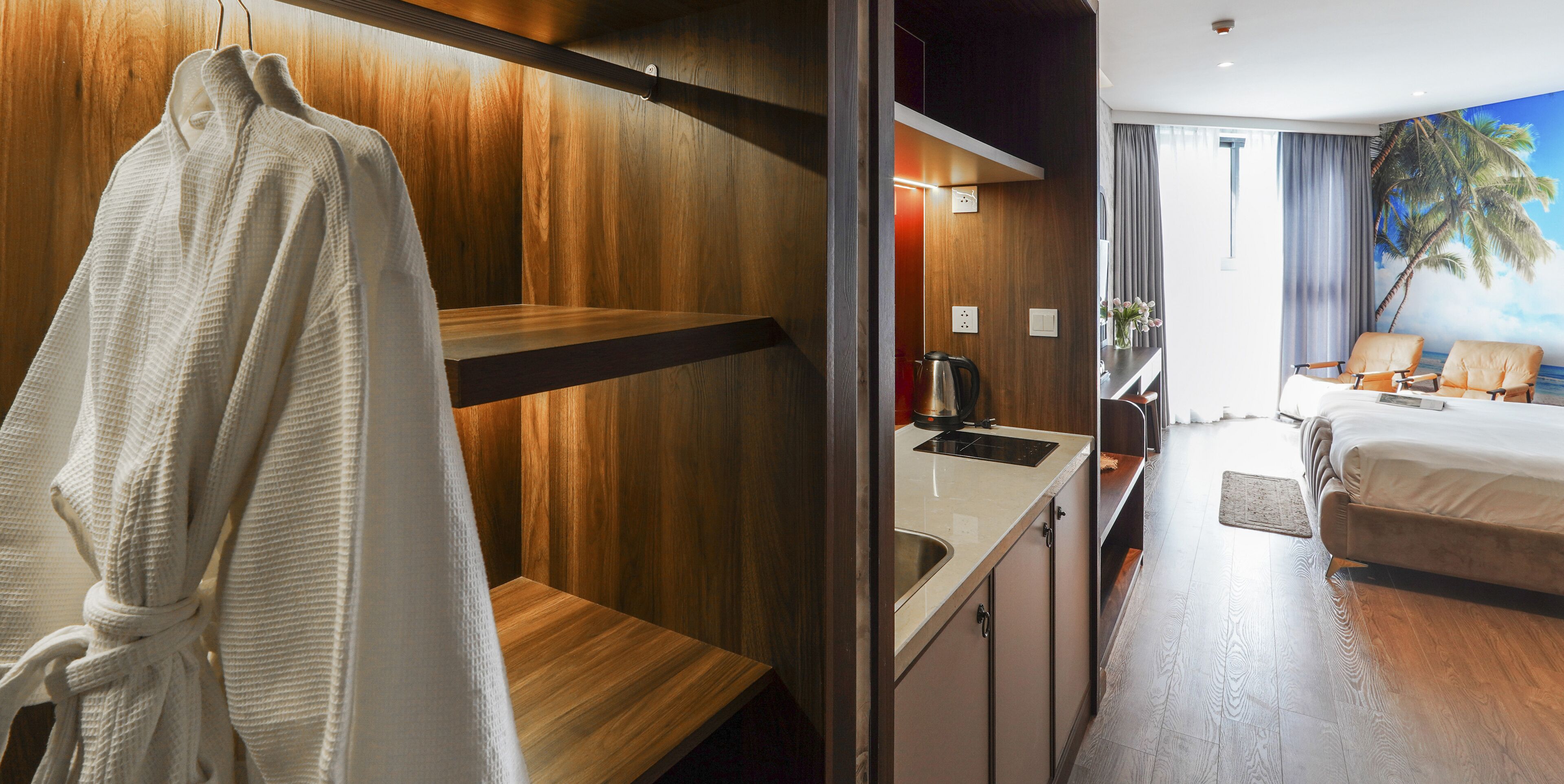 A hotel room with a wooden wall, a sink, a bed, and a view of the ocean.