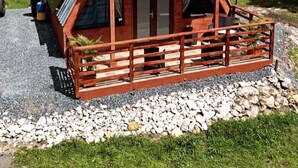 A two-story wooden cabin with a sloped roof, a balcony, and a wind turbine in the background. - Cabaña 787
Scape from reality in a cozy cabin
steps to a geological place. (Lares)