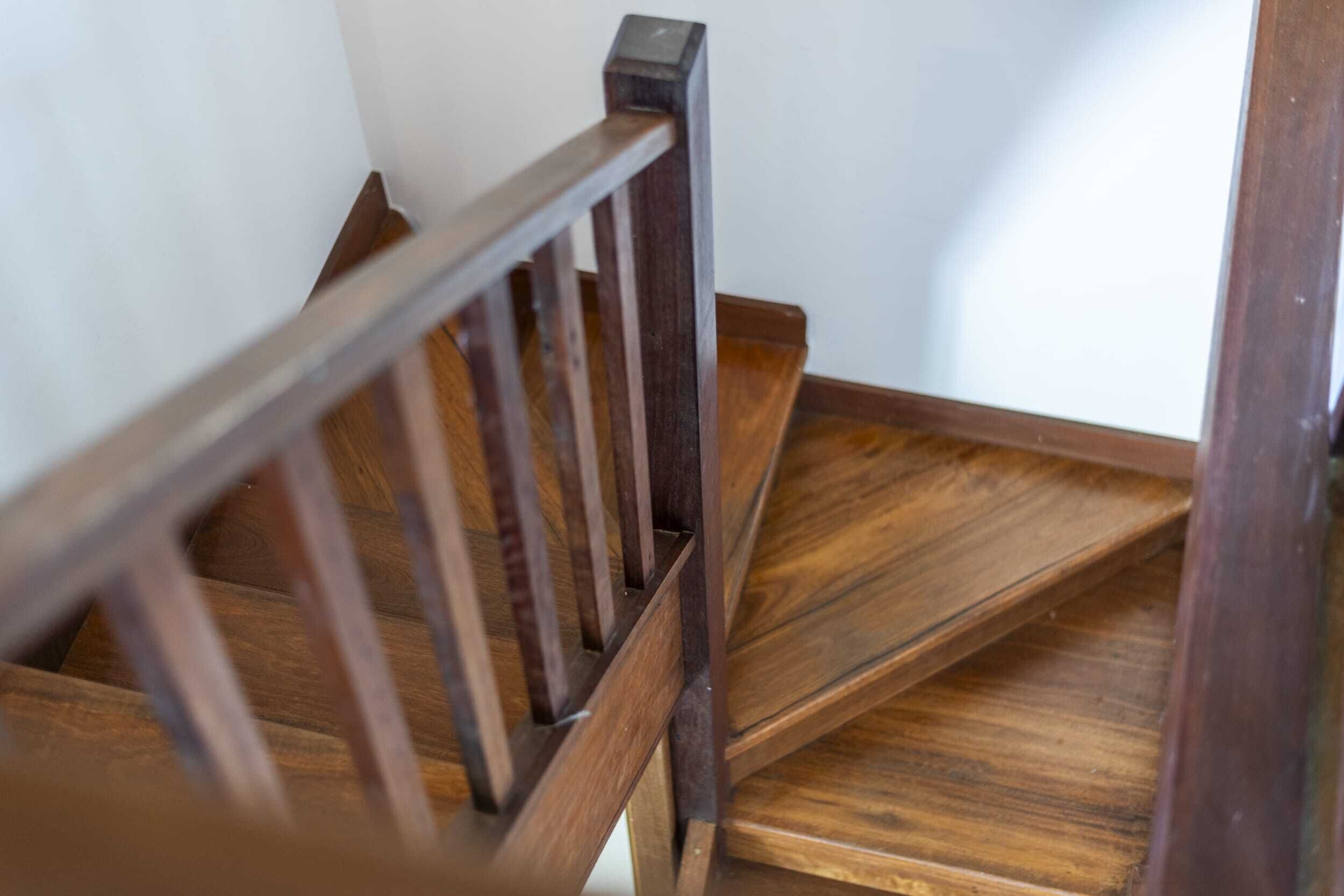 A wooden staircase with a handrail.