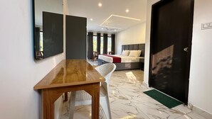 A modern hotel room with a large bed, a desk, and a chair. - Six Seasons Resort (Kaladhungi)