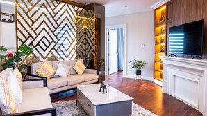 A modern living room with a sofa, coffee table, and decorative items.