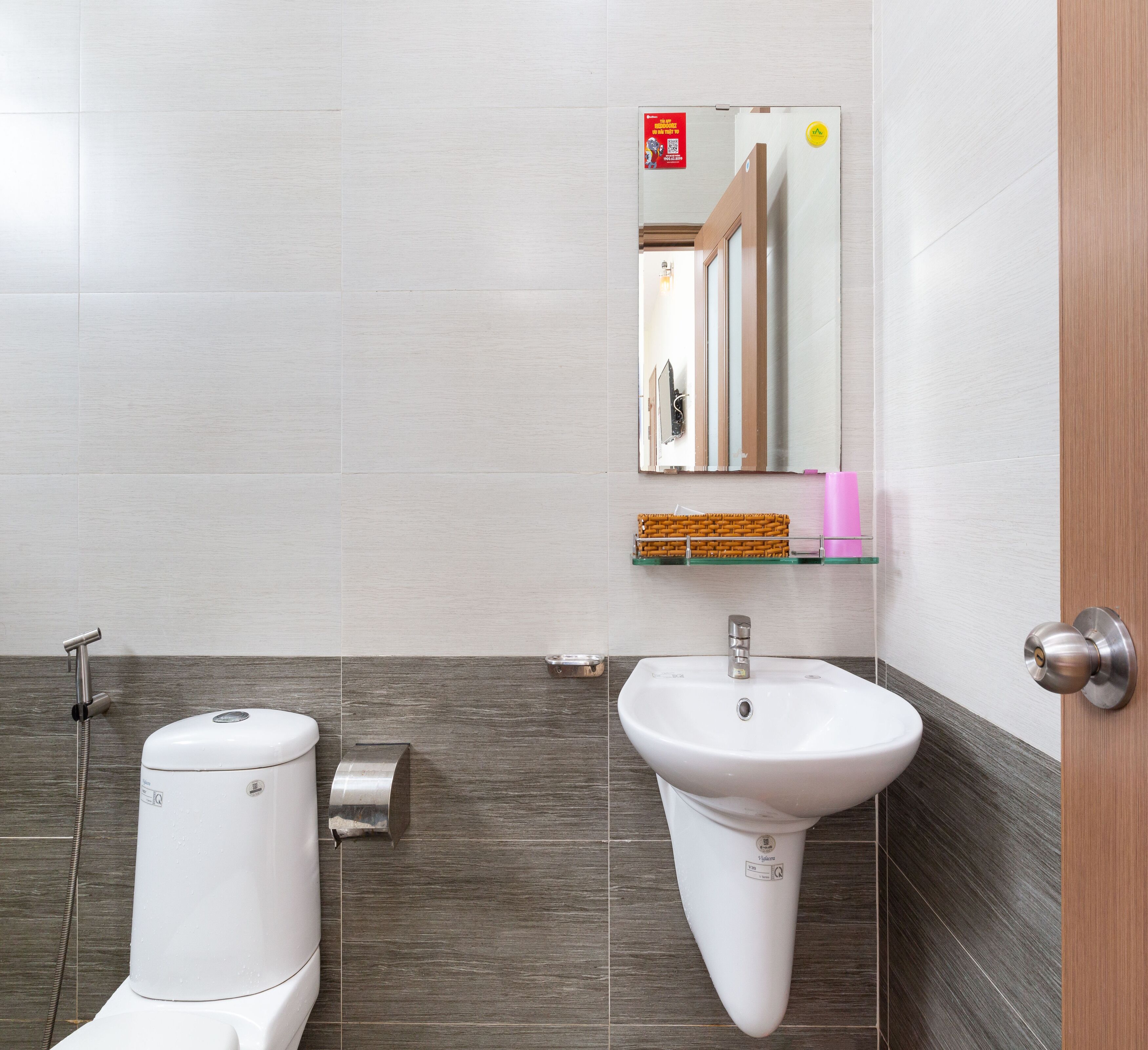 A bathroom with a toilet, bidet, and sink.