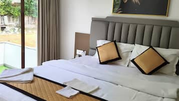 Deluxe Room, Patio, Garden View | In-room safe, soundproofing, iron/ironing board, rollaway beds