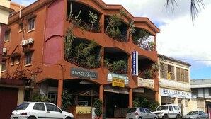 A multi-story building with balconies, a massage therapy center, and a medical clinic. - CENTRAL HOTEL  (Antsiranana)
