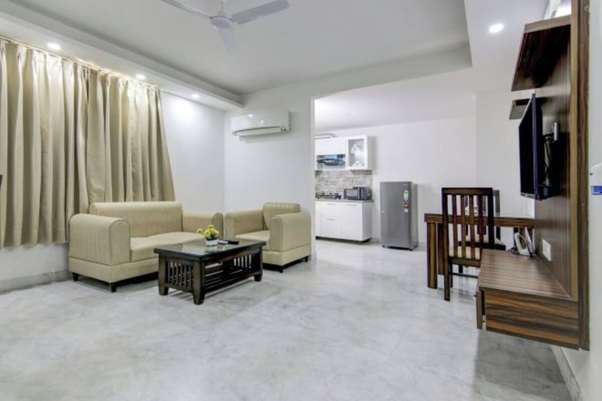 A modern living room with a sofa, coffee table, and TV stand.