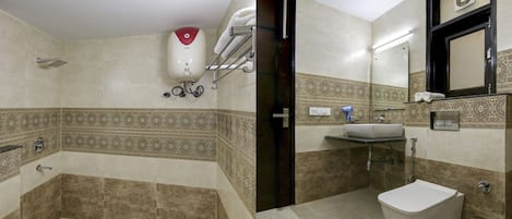 A bathroom with a bathtub, a toilet, and a sink.