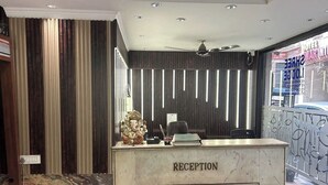 A reception desk with a marble top and a sign that reads "RECEPTION".