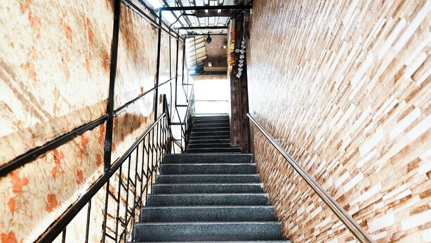 A staircase with metal railings, leading upwards. - Hotel Sai Parikrama (Navi Mumbai)