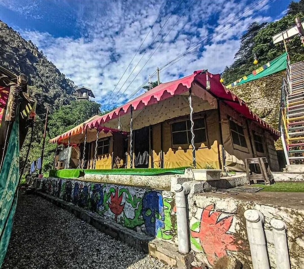 A building with a red roof and a colorful mural on the wall.