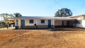 A two-story building with a covered porch and a fenced yard. - 1 Bed Studio Apt - Parking, Wifi, Mountain Views (Scarborough)