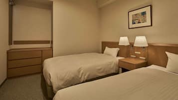 A hotel room with two beds, a dresser, and a nightstand with lamps.