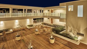 A multi-level outdoor area with wooden flooring, potted plants, and seating arrangements. - Tokyu Vacations Izukogen (Ito)