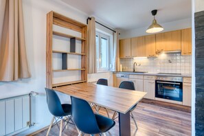 Enjoy cooking in this well-equipped kitchen with a stove, oven, and sink, plus ample storage in the shelf unit.