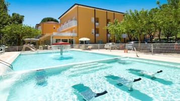 Een buitenzwembad, parasols voor strand/zwembad