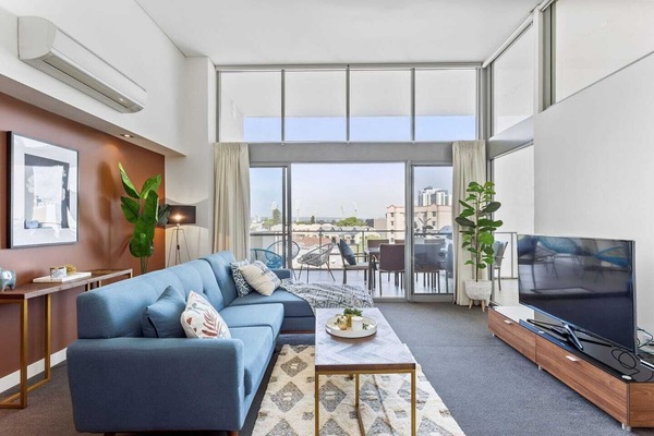 Spacious and light-filled with balcony access—this living room invites you to unwind and enjoy the view.