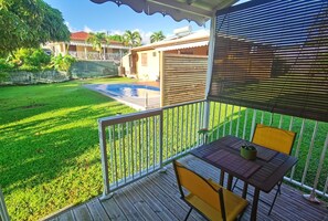Enjoy an outdoor space with a pool, deck, and seating area.