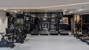 A gym with treadmills, stationary bikes, and exercise equipment. - All Starr Sports (Jaipur)