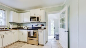 A kitchen with white cabinets, a microwave, an oven, and a dishwasher. - Dtwn St Marys Home Near Waterfront: Pets Welcome! (St. Marys)