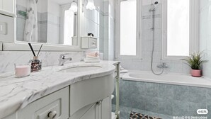 A modern bathroom with a marble sink, a large mirror, a shower, and a potted plant. - Two-room Apartment San Siro-fiera Milano M5 Lilac Segesta (Milan)
