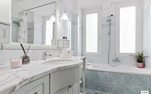 A modern bathroom with a marble sink, a large mirror, a shower, and a potted plant. - Two-room Apartment San Siro-fiera Milano M5 Lilac Segesta (Milan)