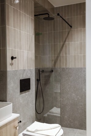 Shower, hair dryer, towels, toilet paper