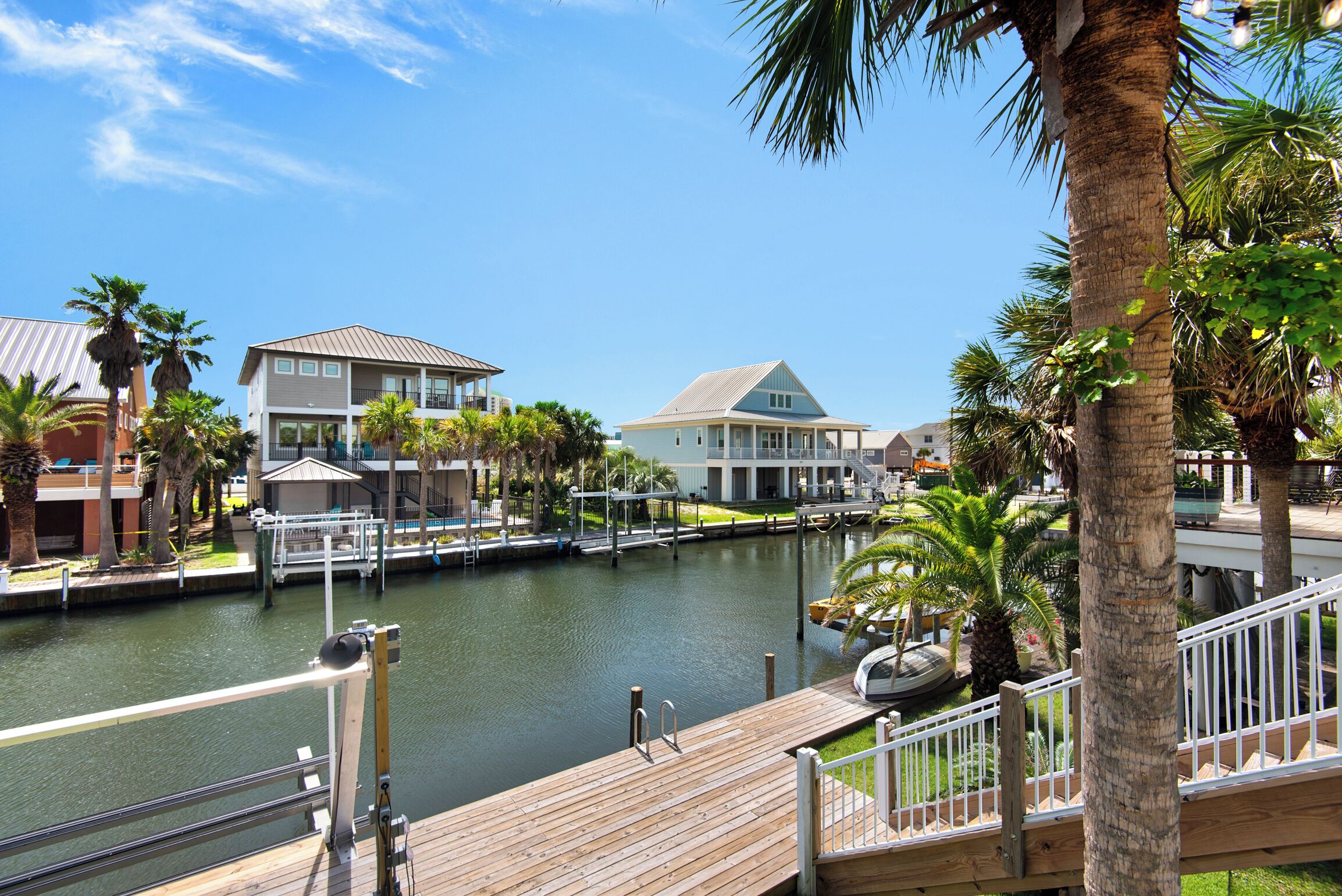 A waterfront property with a wooden deck, a marina, and buildings with balconies.