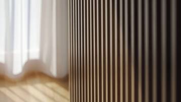 A close-up of a textured wall with vertical lines.