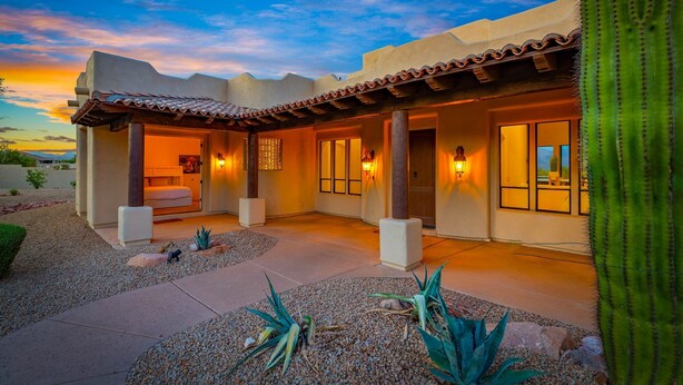 A modern house with a patio, a bedroom, and a living area.
