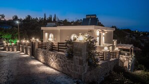 A modern building with a stone facade, arched windows, and a sign reading "LAZAI." - Lazai Villa (Zakynthos)