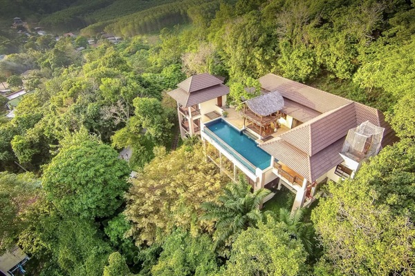 Aerial view of the villa nestled in the rainforest above the bay