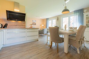 Enjoy a spacious kitchen and dining area with a large island, appliances, and seating for four.