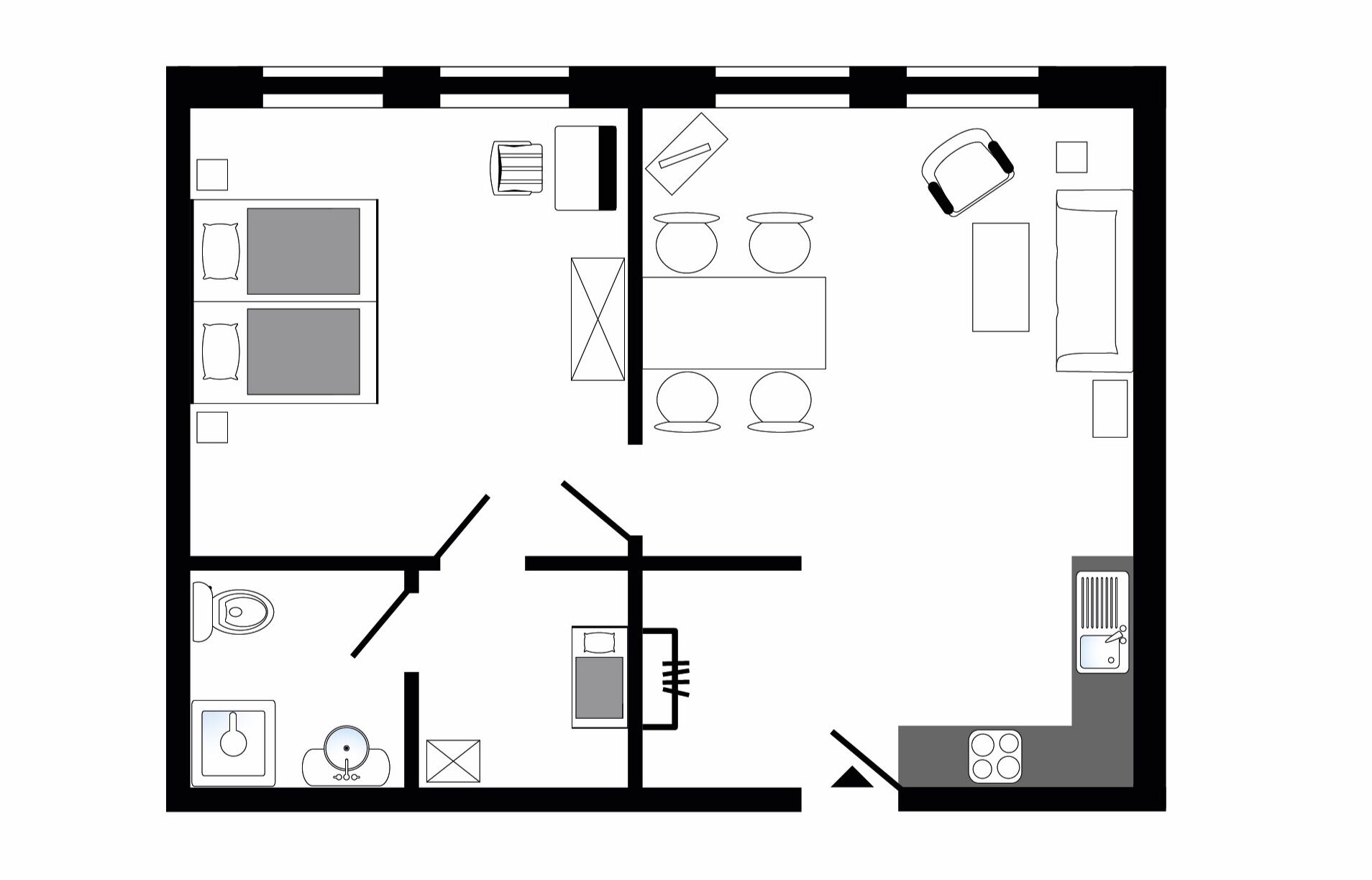 A floor plan of a hotel room with a bed, a desk, a chair, a wardrobe, a bathroom, and a small kitchenette.