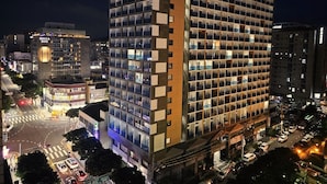 A multi-story hotel with a modern design, featuring a mix of glass and concrete facades, and a prominent signage indicating it is a hotel. - Morning Madrid (Jeju City)