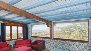 A room with a high ceiling, wooden beams, and large windows offering a view of the landscape. - Villa San Vito - Private villa with pool (Valderice)
