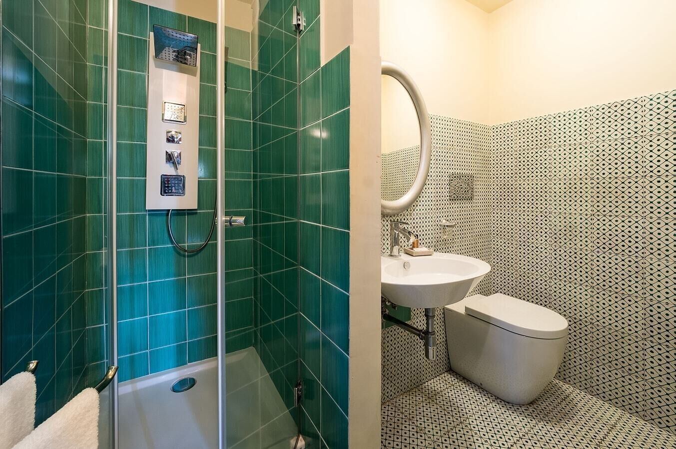 A bathroom with a glass-enclosed shower, a sink, and a toilet.