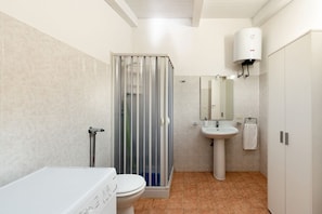 A bathroom with a shower, toilet, sink, and a towel rack. - Corrado Residence (Acqua) near Marzamemi (Reitani)