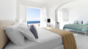 A bedroom with a bed, a TV, and a view of the sea. - Villa Mia - Sea front private villa close to town (Napoli)