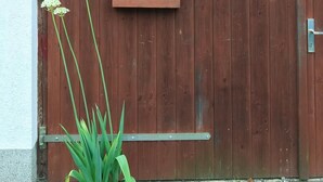 Una puerta de madera con un cartel de bienvenida y un farol encima.