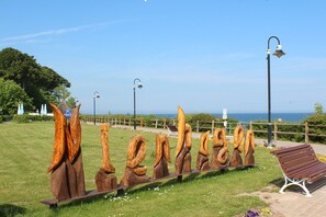 Stunning sculptures line a serene outdoor space, inviting guests to sit and take in the breathtaking view.