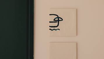 Two signs on a wall: one with a symbol and the number 124.