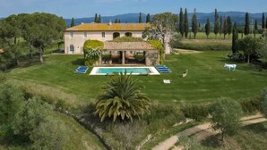 A large house with a swimming pool, surrounded by a well-maintained lawn and trees. - Villa Melissa - Stunning Tuscan Villa With Pool (Roccastrada)