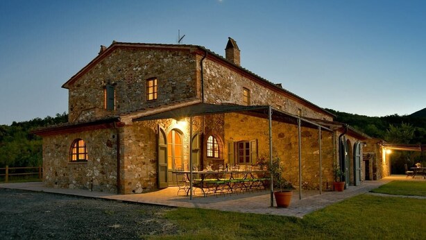 A stone house with a covered patio and a small garden. - Villa Bibbona - Private villa with heated pool (Montecatini Val di Cecina)