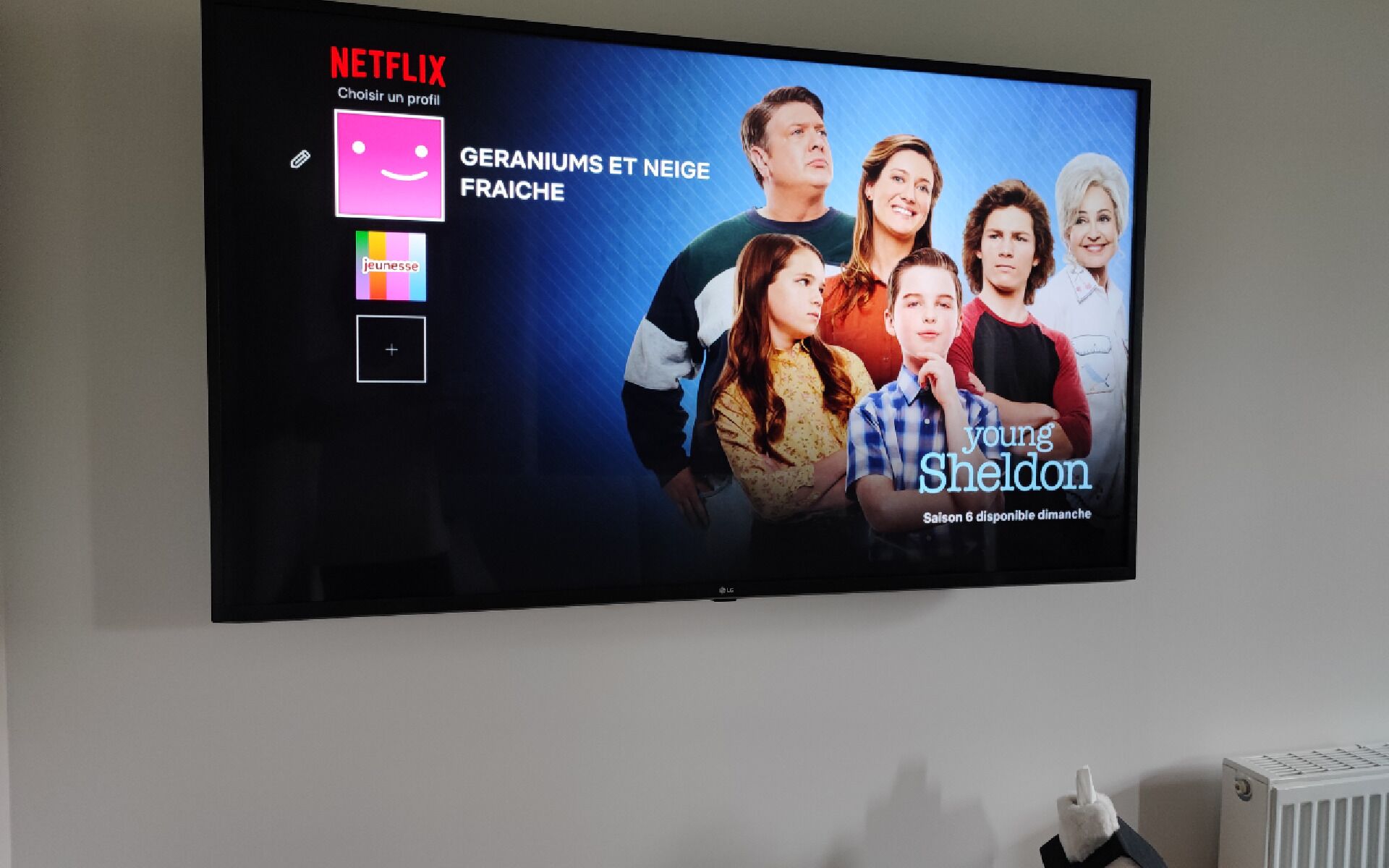 Ein Fernseher zeigt eine Netflix-Oberfläche mit einem Familienfilm, Staffel 6 von "Young Sheldon", verfügbar am Sonntag.