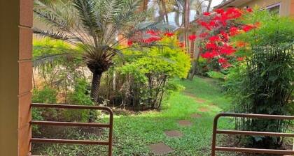 Quiet and peaceful hidden gem surrounded by lush greenery and vibrant flowers.