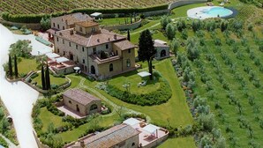 A large estate with multiple buildings, a swimming pool, and well-maintained gardens.