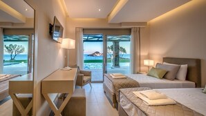 A modern hotel room with a desk, two beds, a TV, and a view of the sea. - Villa Zenais, Luxury with swimming pool (Koridallos)