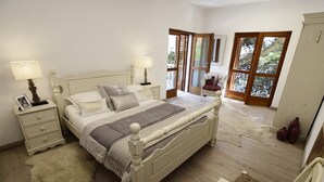 A bedroom with a large bed, two bedside tables, a chair, and a window with a view of trees. - Villa Josipa - Luxury modern villa with pool in Croatia (Puntinak)